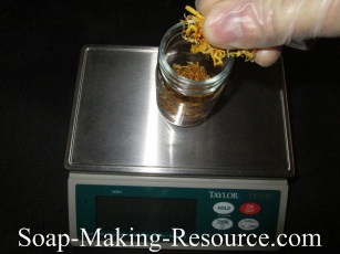 Measuring Calendula Petals into Mason Jar