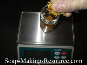 Measuring Calendula Petals into Mason Jar Measuring Calendula Petals into Mason Jar