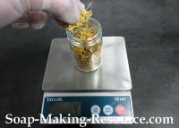 Measuring Calendula Petals into Mason Jar Measuring Calendula Petals into Mason Jar