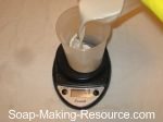 measure out almond milk for soap making
