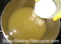 Pouring Almond Milk into Honey Oatmeal Soap Pouring Almond Milk into Honey Oatmeal Soap