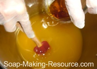 Pouring Citrus Essential Oil Blend into Honey Soap Recipe Pouring Citrus Essential Oil Blend into Honey Soap Recipe