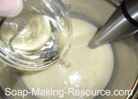 Pouring Essential Oils into Goat's Milk Soap Pouring Essential Oils into Goat's Milk Soap