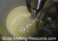 Pouring Essential Oil Blend into Handmade Soap Recipe