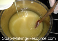 Pouring Goat's Milk Lye Solution into Oils Pouring Goat's Milk Lye Solution into Oils