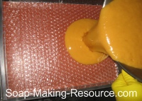 Pouring Soap into Bubble Wrap Lined Mold Pouring Soap into Bubble Wrap Lined Mold