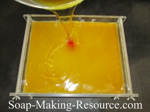 Pouring the Emu Oil Lotion Bar Batch into a Mold Pouring the Emu Oil Lotion Bar Batch into a Mold