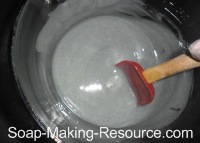 Stirring Woad Powder into Handmade Soap Recipe