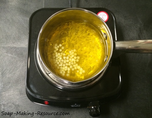Melting the Yellow Beeswax into the Golden Jojoba Oil