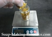 Measuring Calendula Petals into Mason Jar