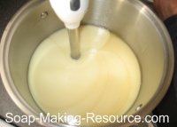 mixing calendula soap with stick blender