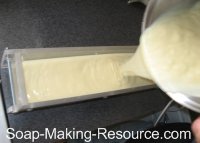 pouring calendula soap into mold