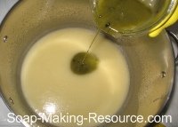 Pouring Comfrey Colored Soap into Rest of Batch