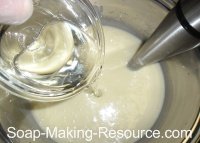 Pouring Essential Oils into Goat's Milk Soap