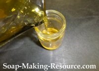 Pouring the Strained Jojoba Oil Back into the Mason Jar