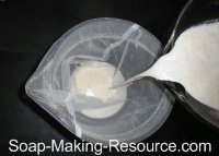 Pouring Walnut Milk into Container for Filtering