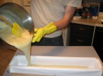 pouring soap into wooden miter box mold